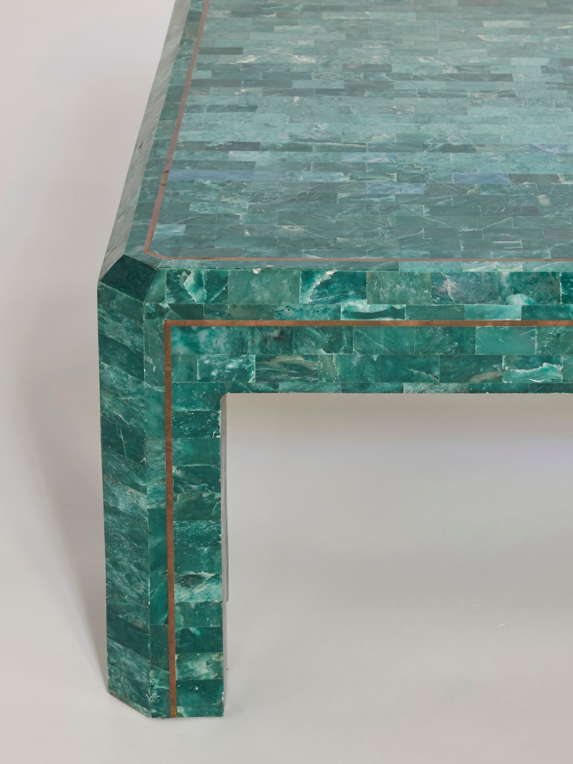 A close-up of the Emerald Onyx Inlay Console Table, featuring a glossy green onyx surface with fine copper inlays and crisp edges against a neutral background—ideal for sophisticated modern interiors.