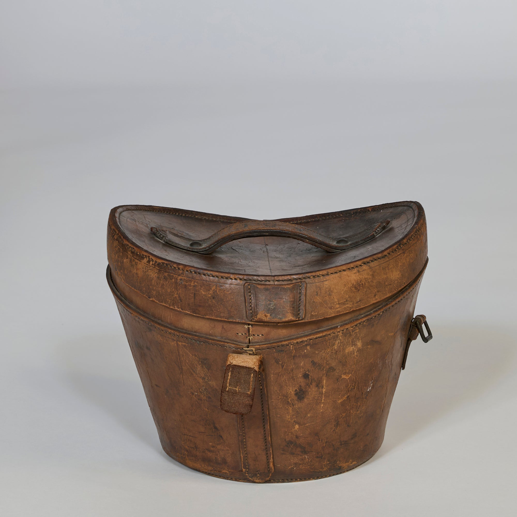 The Antique Leather Storage Case features vintage brown leather, a curved lid, top handle, and front lock, showcased on a plain light background.