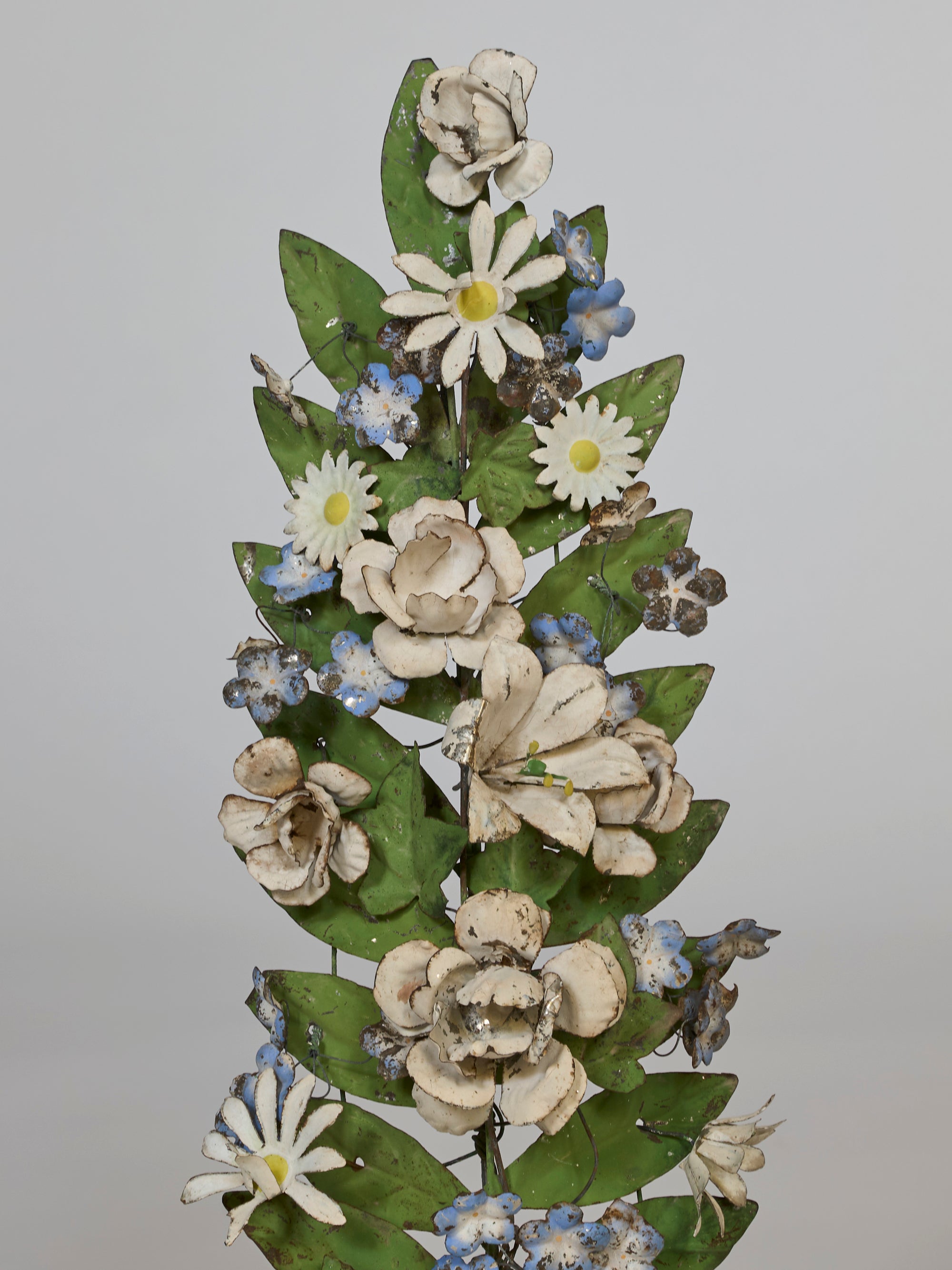 Decorative floral arrangement with white and green flowers on a gray background