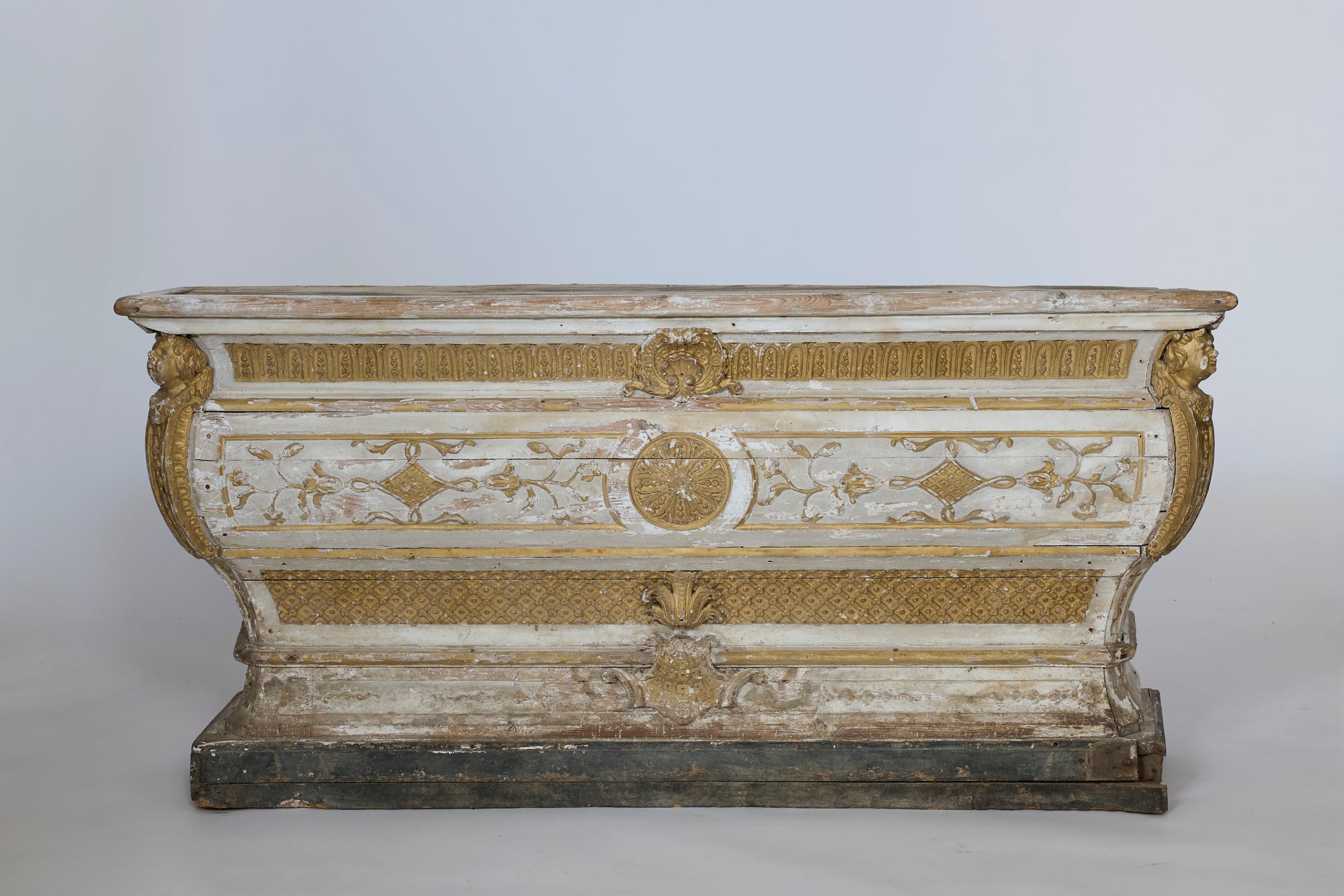 Decorative wooden chest with gold and white detailing on a plain background