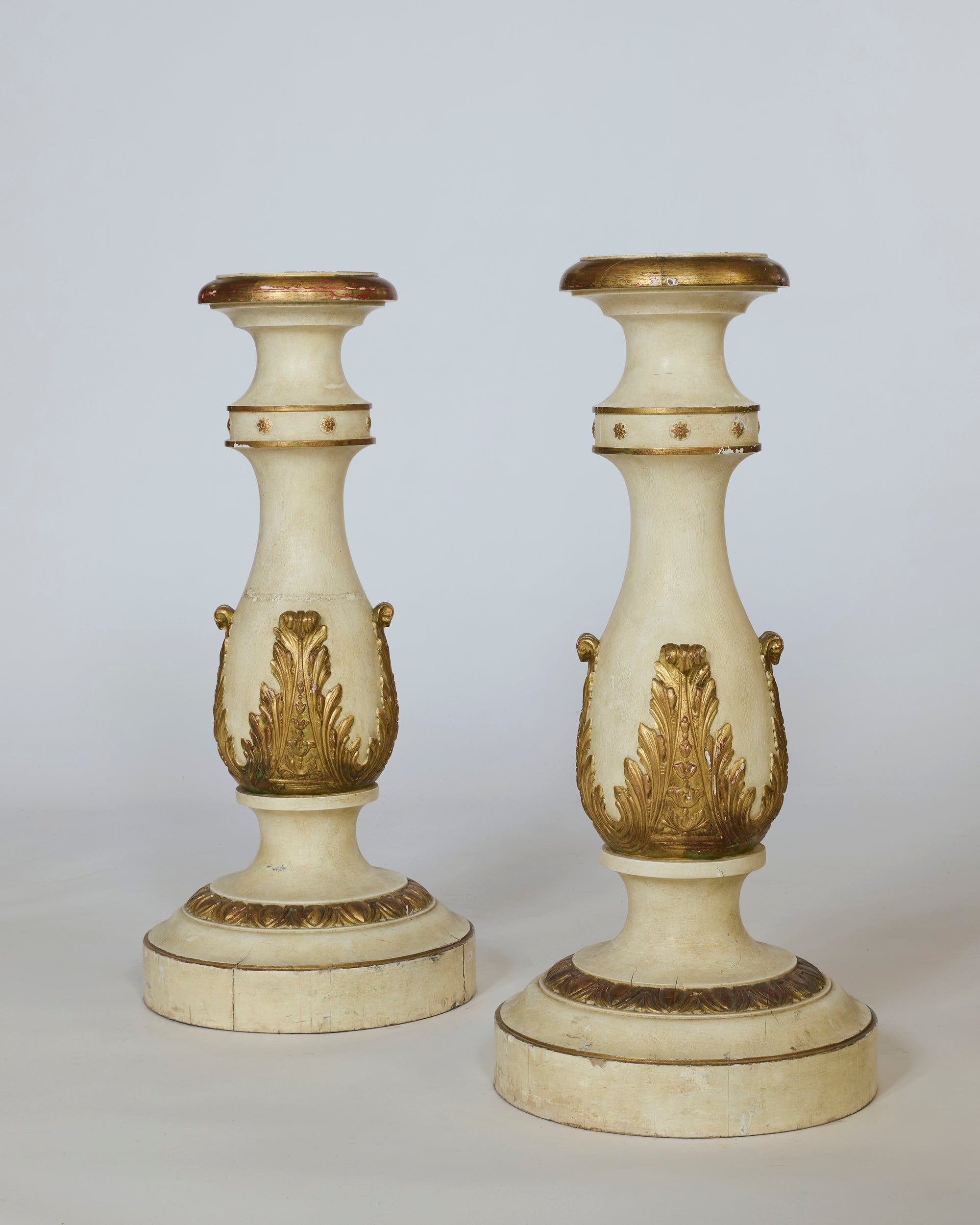 Pair of decorative candlesticks with gold accents on a white background