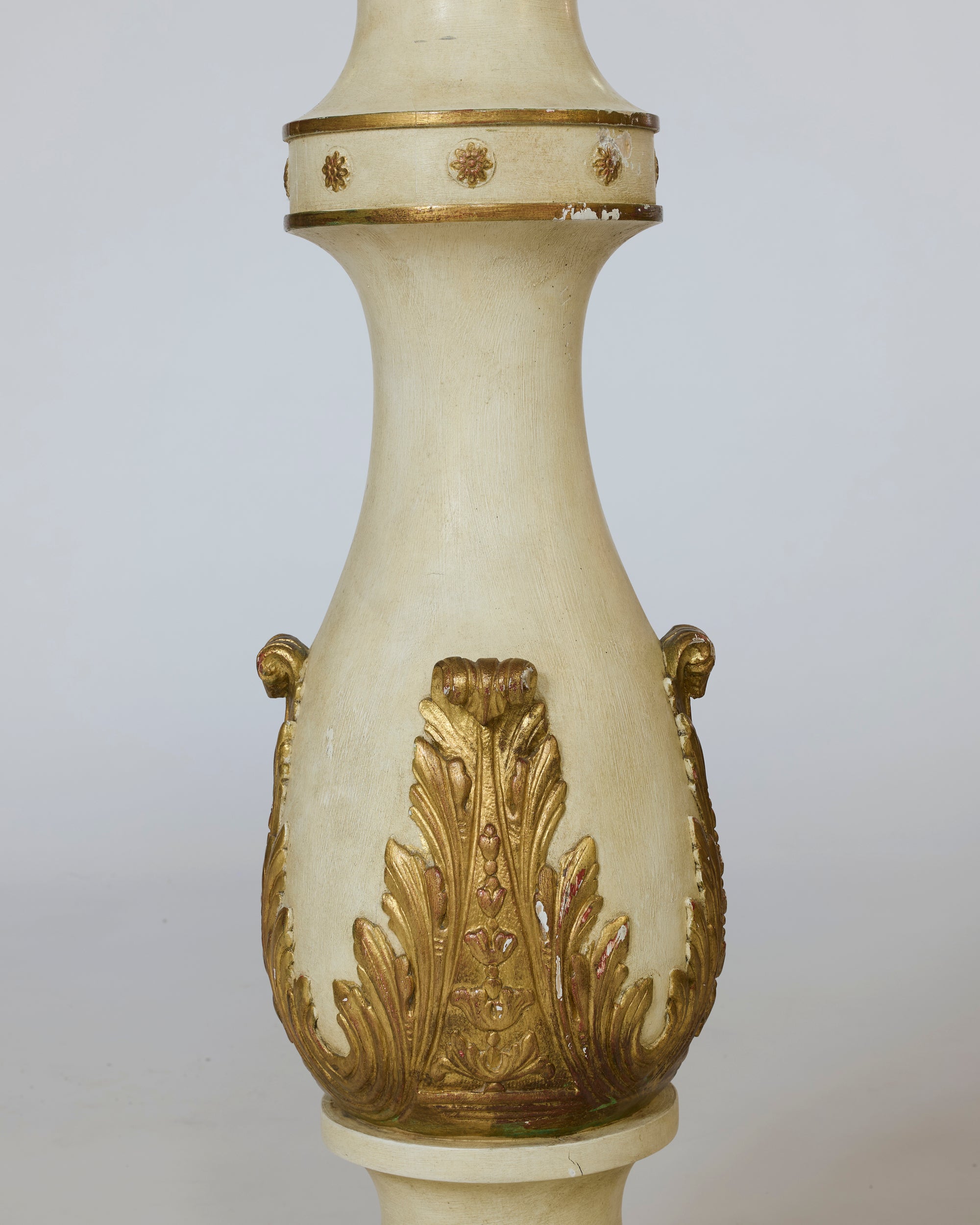 Decorative vase with gold leaf patterns on a plain background