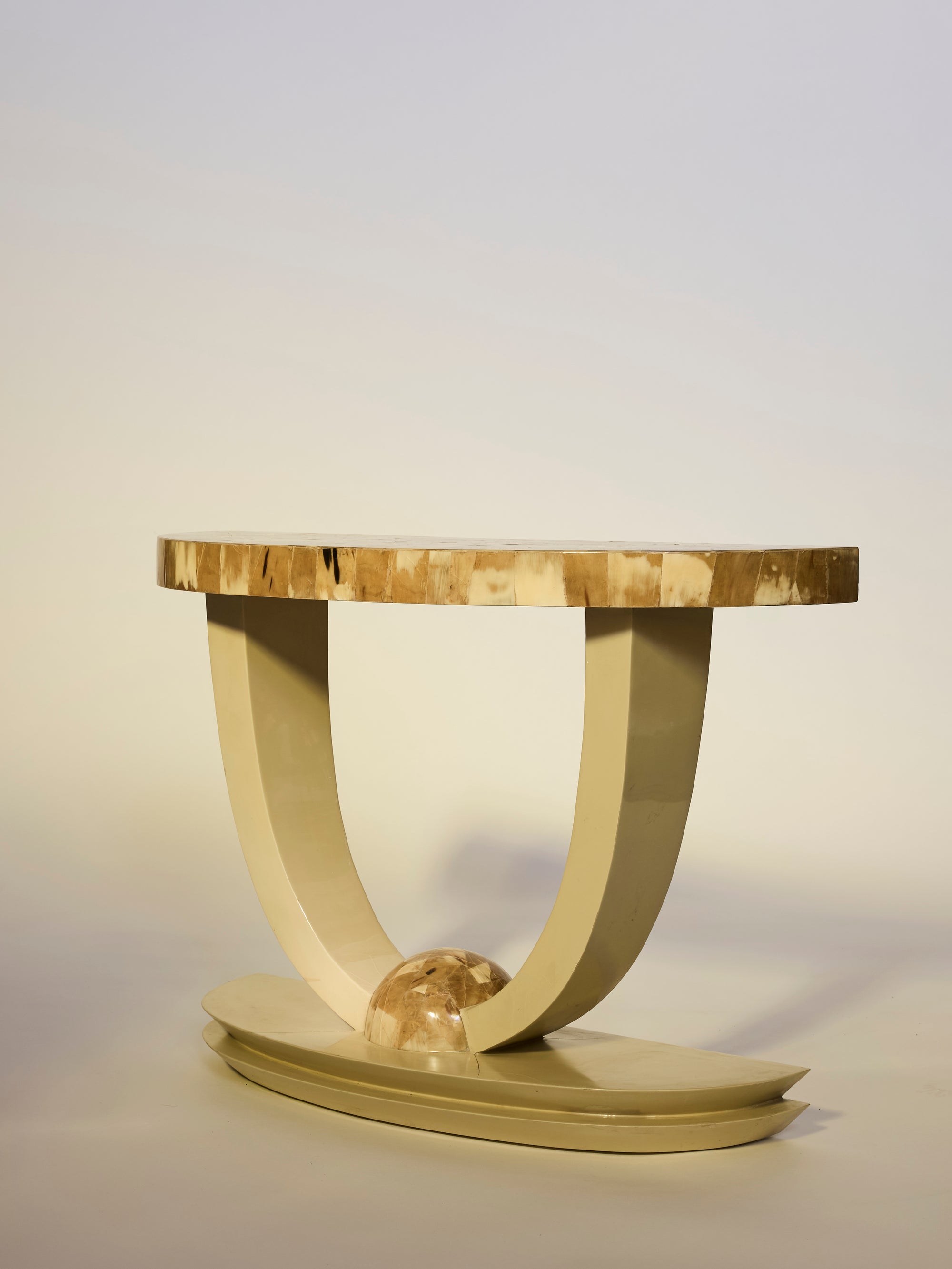 Decorative table with a gold finish on a plain background