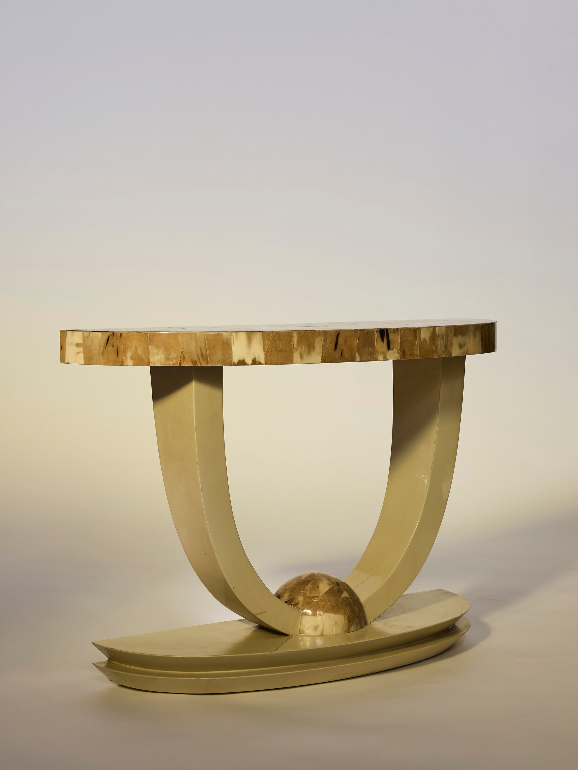 Modern side table with a wooden top and curved base on a plain background
