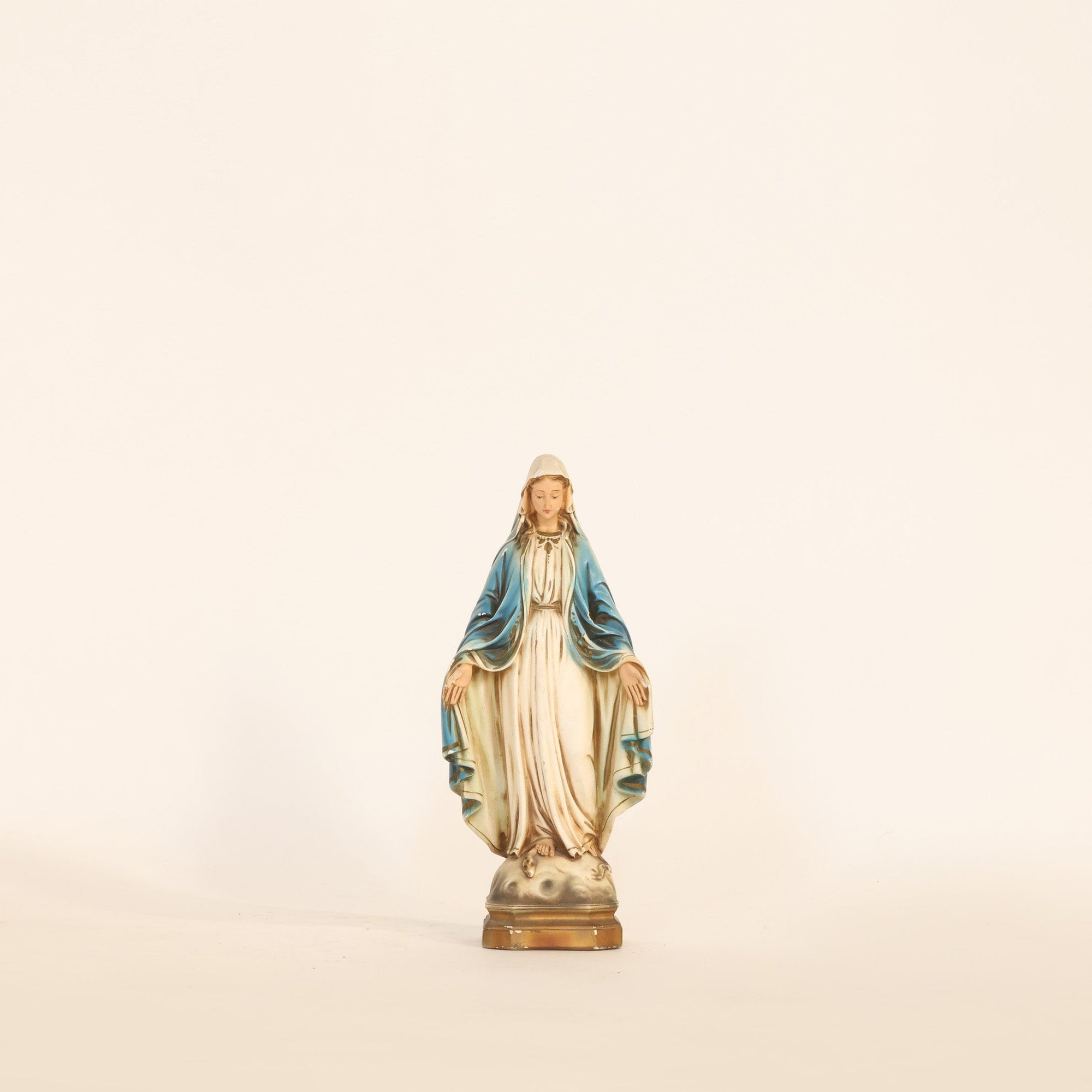 Statue of a religious figure on a beige background