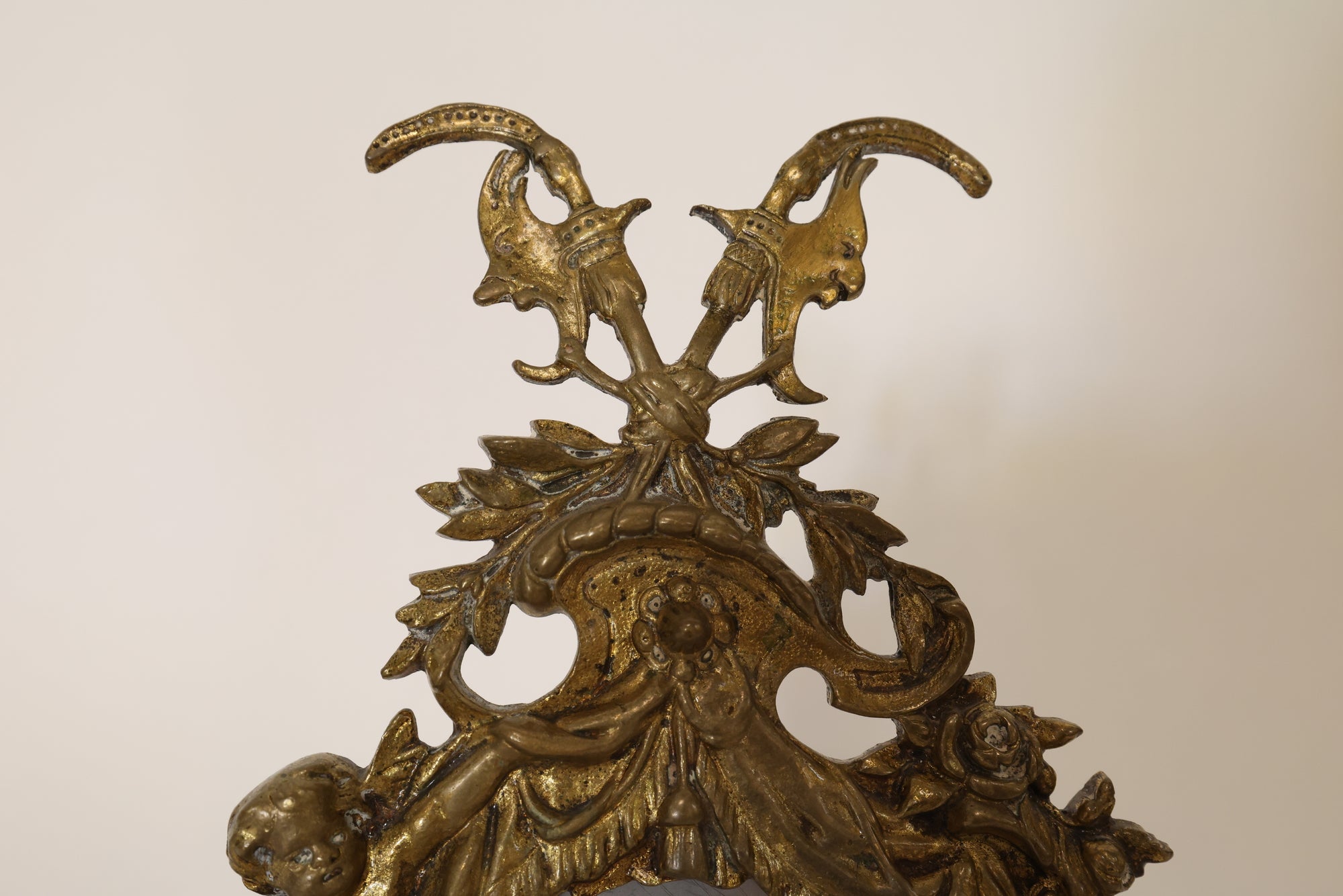 Close up of decorative gold mirror on a beige background