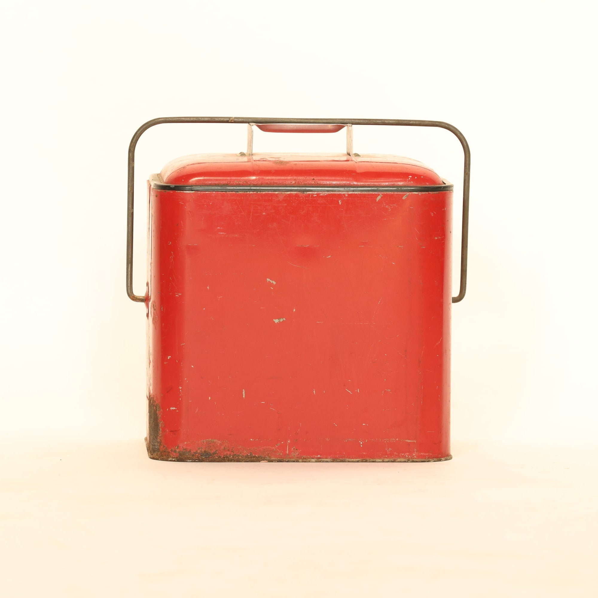 Vintage red metal box with a handle on a white background
