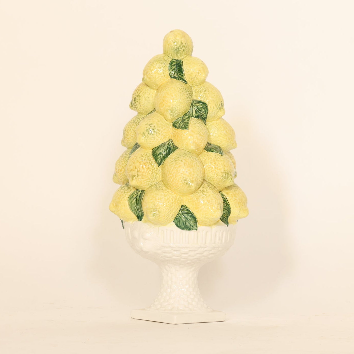 Decorative object resembling a lemon tree on a white background