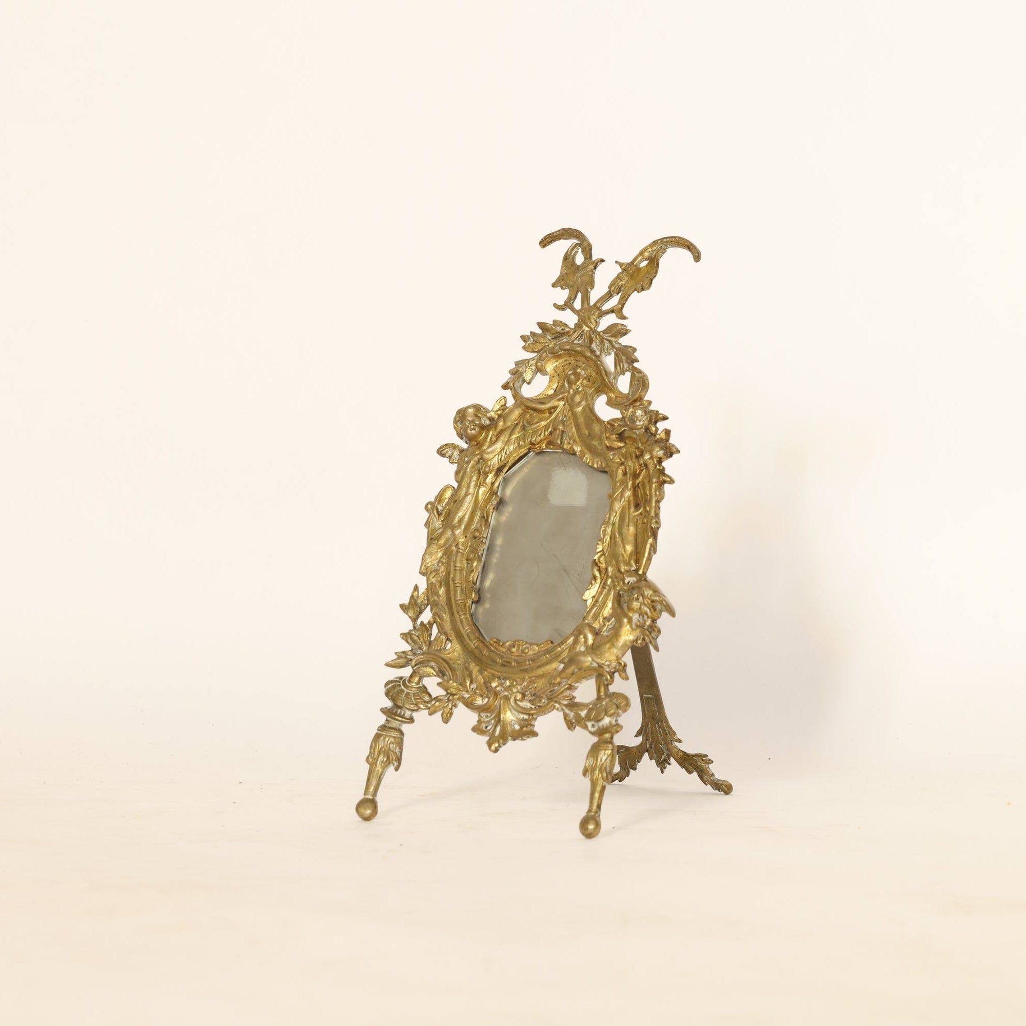 Decorative gold mirror on a beige background