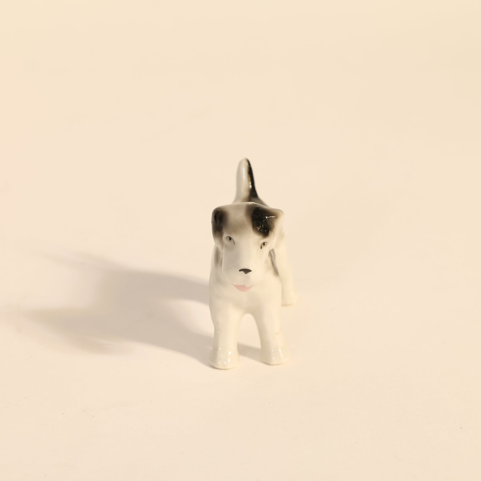 Small dog figurine on a beige background