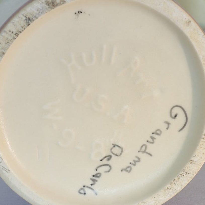 The base of the Vintage Hull Floral Vase by Euro Trash features embossed Hull Art U.S.A W-6-8 and handwritten "Grandmas Dec 96." Its cream color and slight edge discoloration highlight its retro charm.