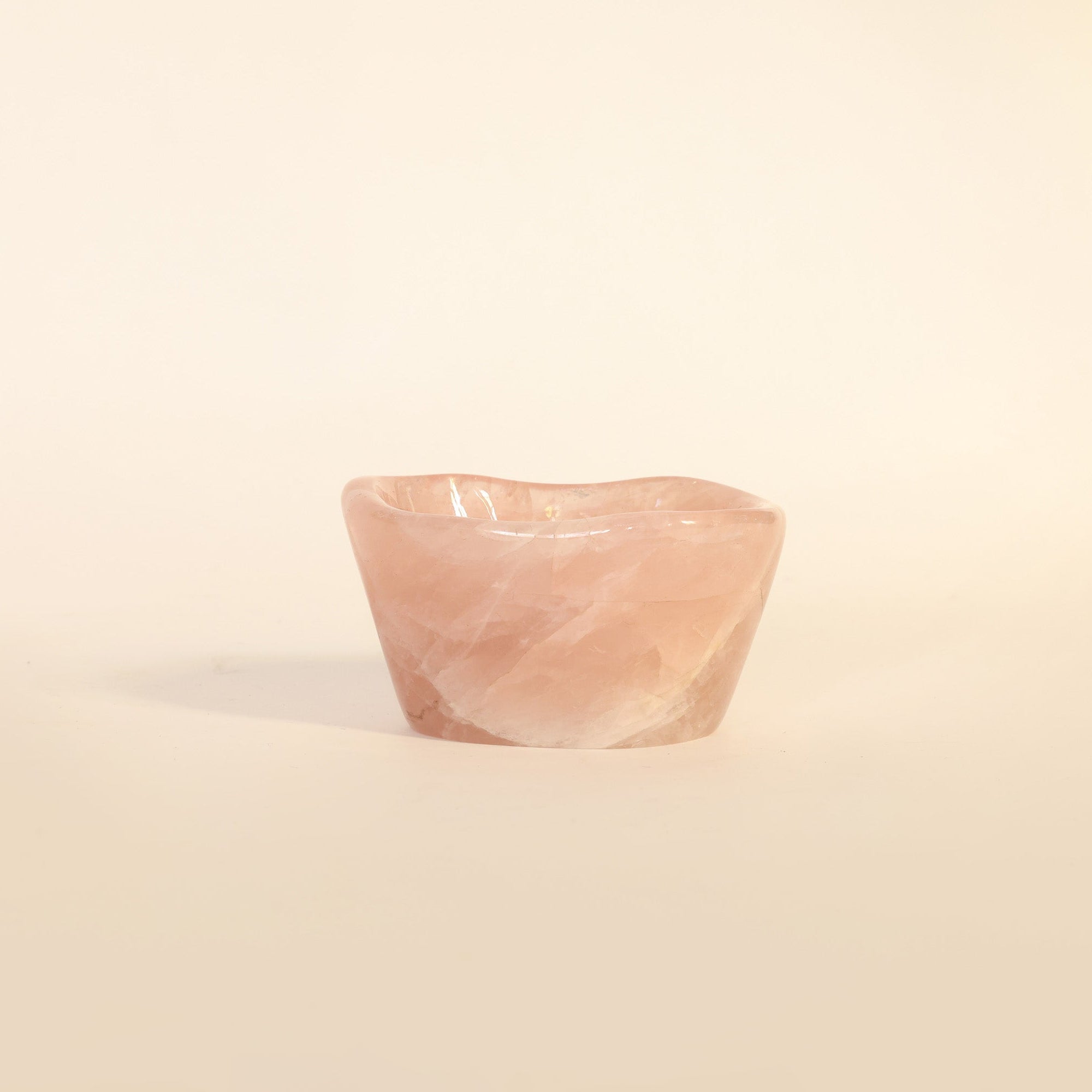 Small pink stone on a beige background