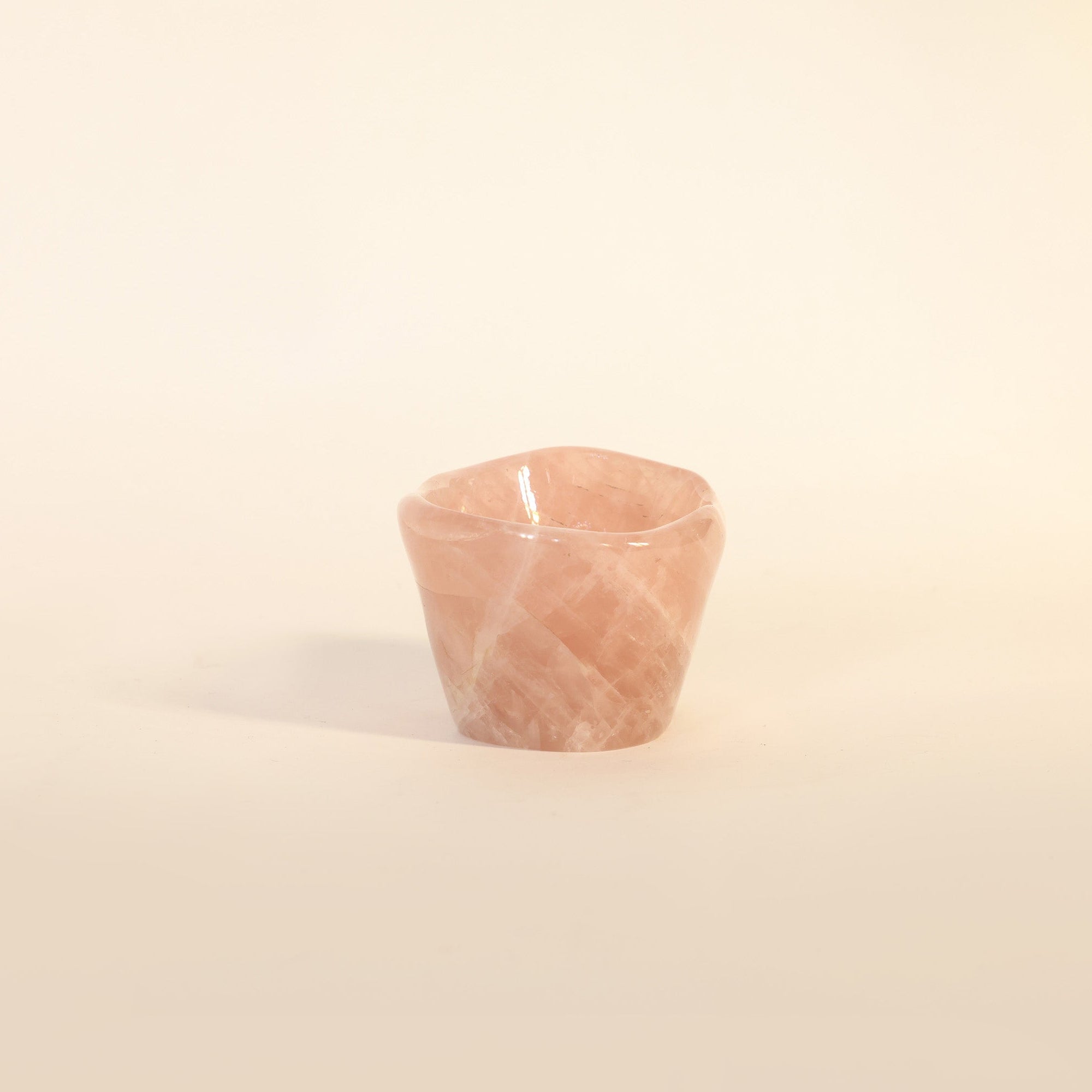 Small pink stone on a beige background