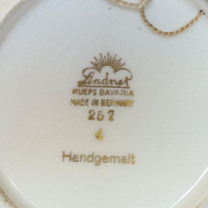 Close-up of a Vintage Crest Porcelain Trinket Dish with Gold Rim by Euro Trash, featuring an intricate gold mark and symbols on the base.