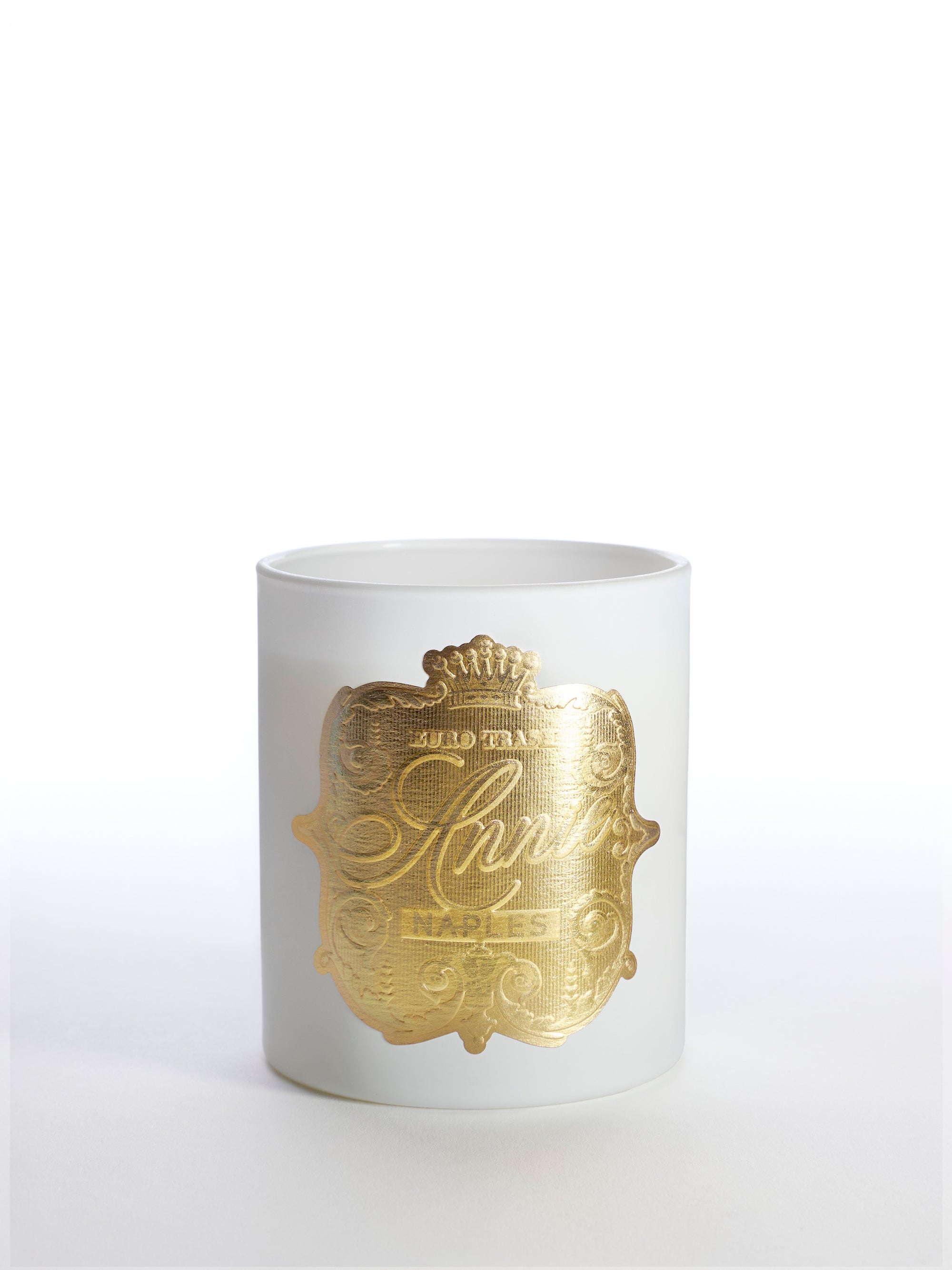 The Naples candle features a white jar with an ornate gold label, crown, and "NAPLES" at the center. This scented soy candle offers a clean burn and subtle floral fragrance. Set against a plain white background.