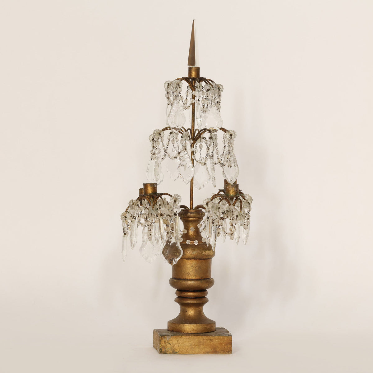 Vintage-style candelabra with crystal accents on a plain background