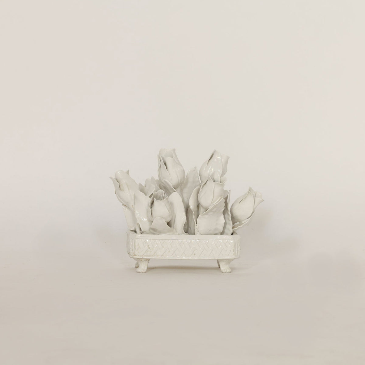 Decorative white ceramic plant on a beige background