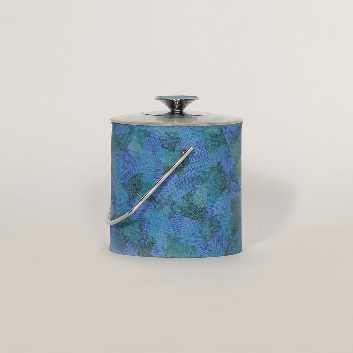 The Euro Trash Annie Mid Century Blue Lucite Ice Bucket features a blue and green geometric pattern, blue lucite accents, silver lid with round handle, and curved carrying handle—ideal for adding modern flair to any light backdrop.