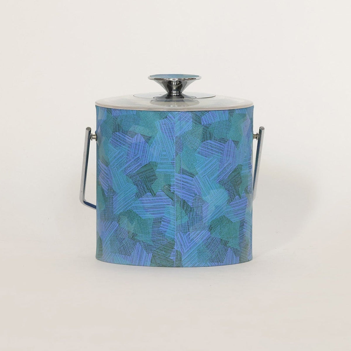 The Mid Century Blue Lucite Ice Bucket by Euro Trash Annie features a blue and teal geometric pattern, silver lid, side handles, and bold blue lucite accents—perfect for adding modern style to your decor.