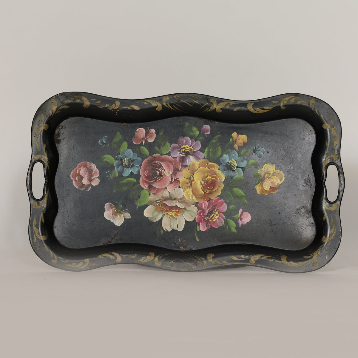 Decorative tray with floral design on a plain background