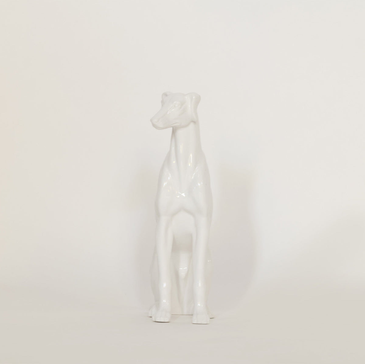 vintage white ceramic dog sculpture on white background.