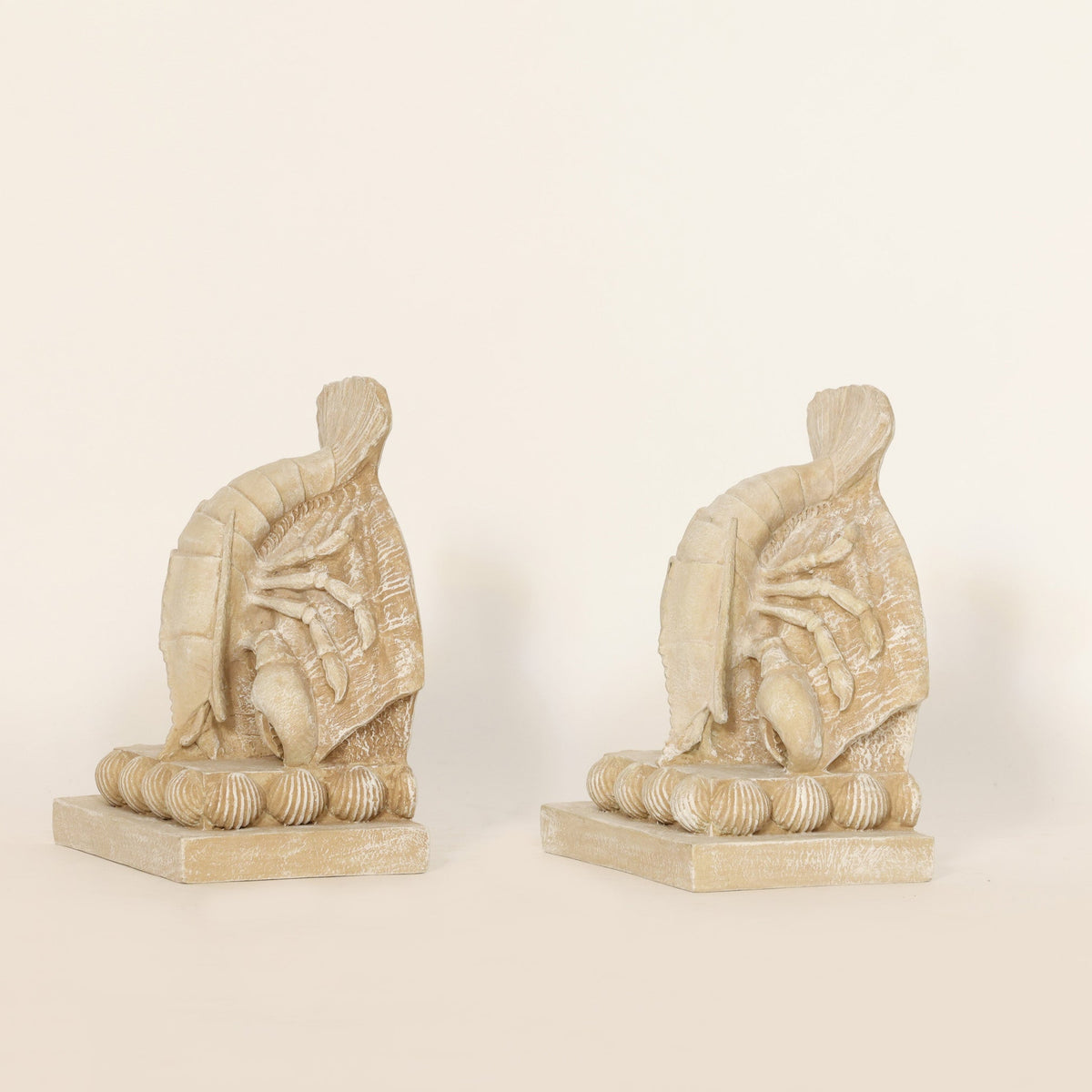 2 Coastal Lobster Sculptural Bookends on beige background.