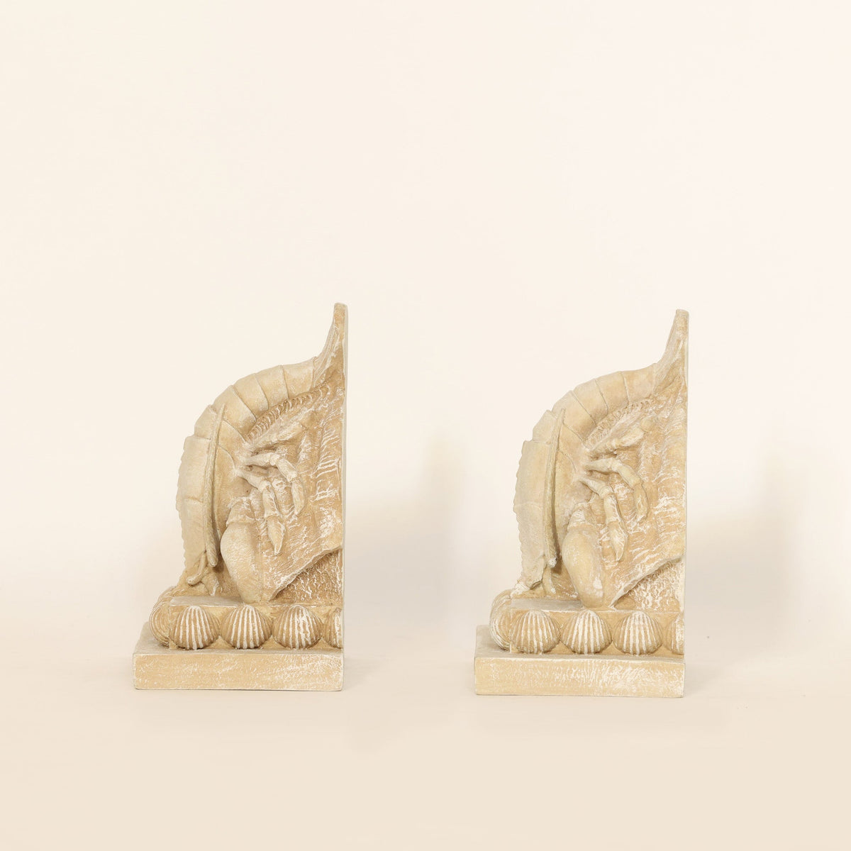 Pair of Coastal Lobster Sculptural Bookends on beige background.