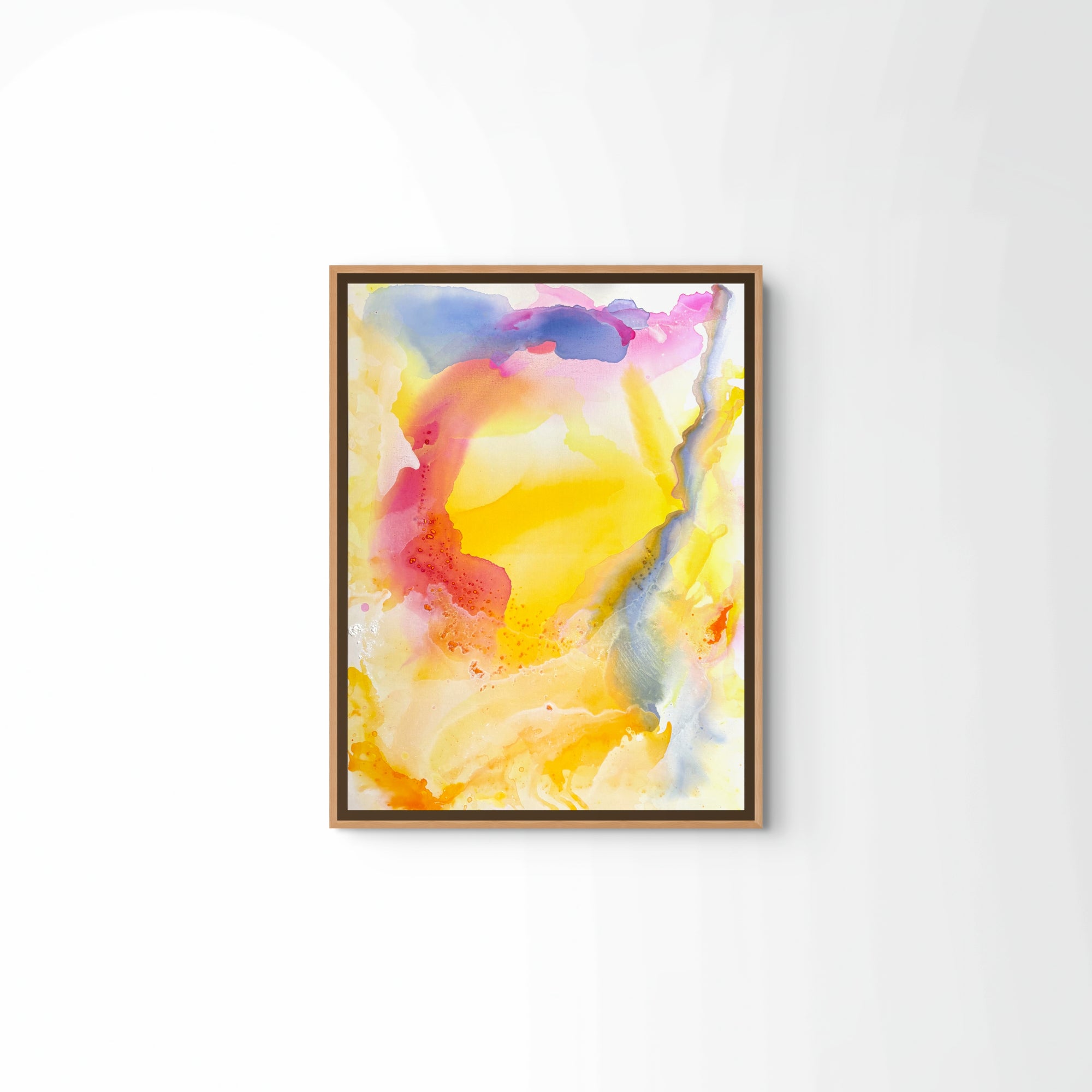 Sunset by the ocean" by Euro Trash is a framed abstract painting featuring vibrant yellow, orange, pink, and blue hues inspired by Andalucian art, shown on a white wall.