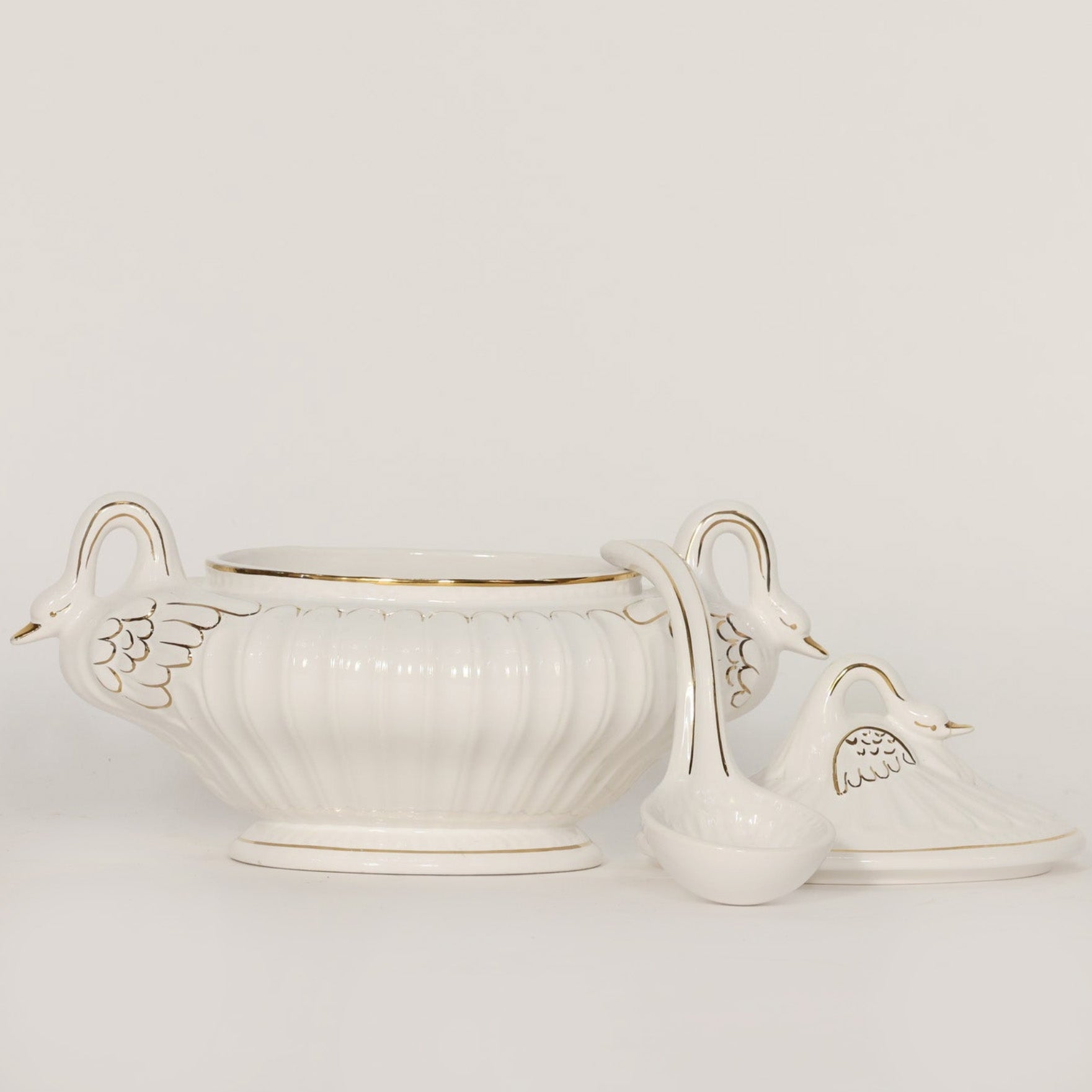 White ceramic tureen with decorative lid on a light gray background
