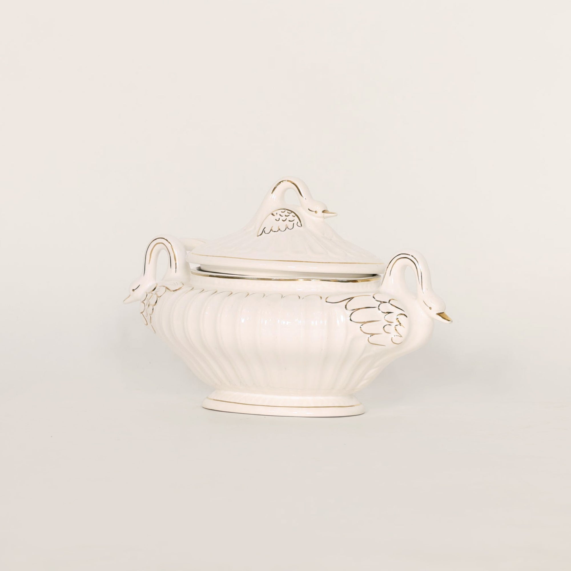 White ceramic tureen with lid on a light gray background