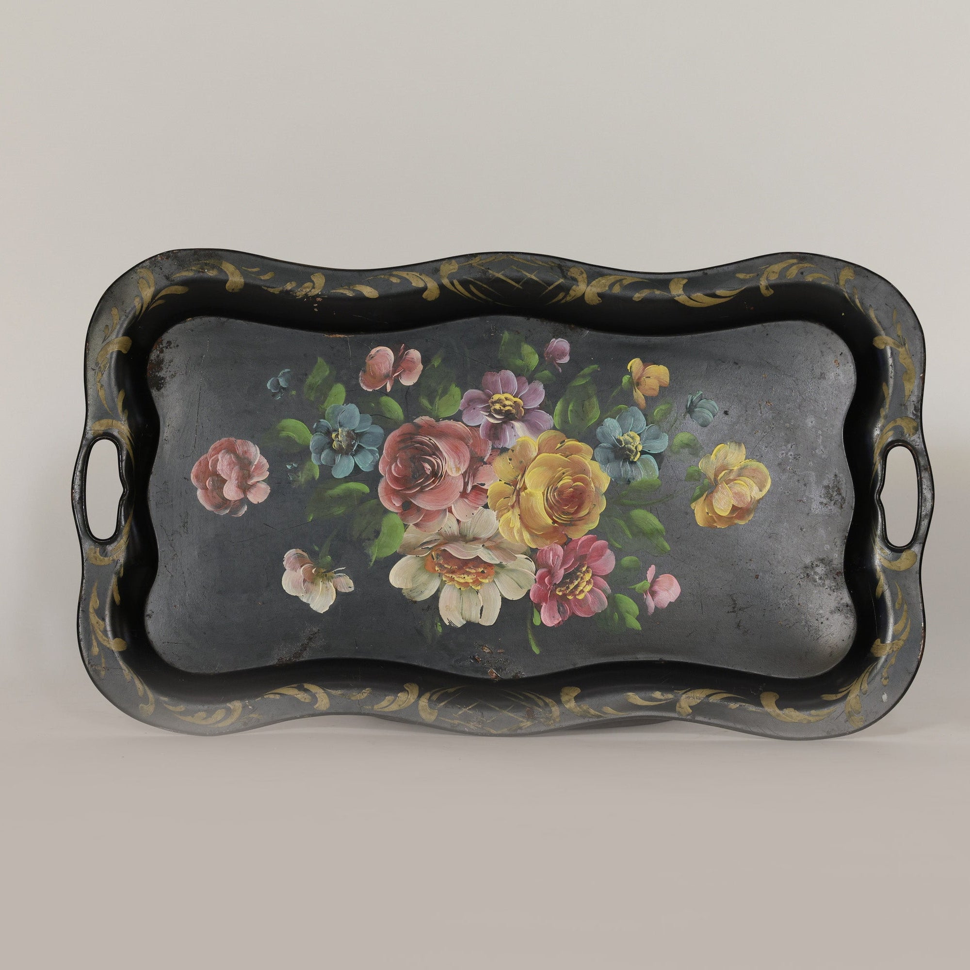 Decorative tray with floral design on a plain background