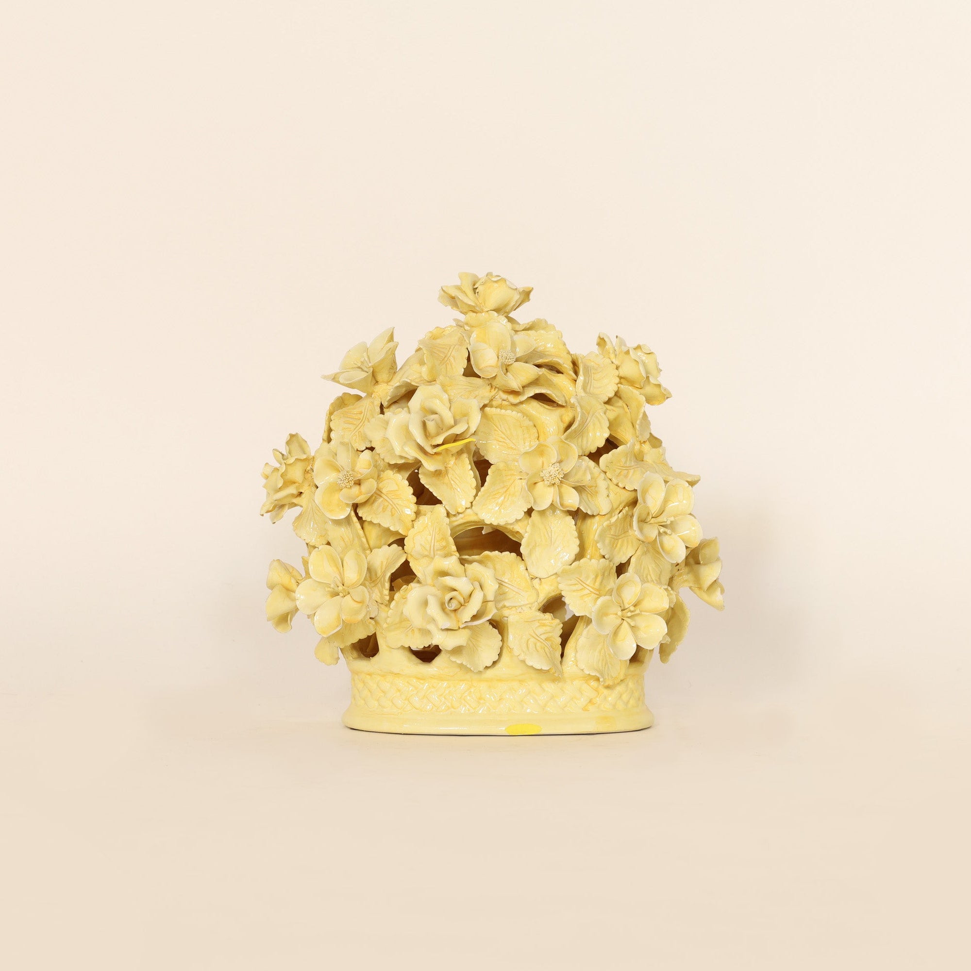 Decorative yellow floral sculpture on a beige background