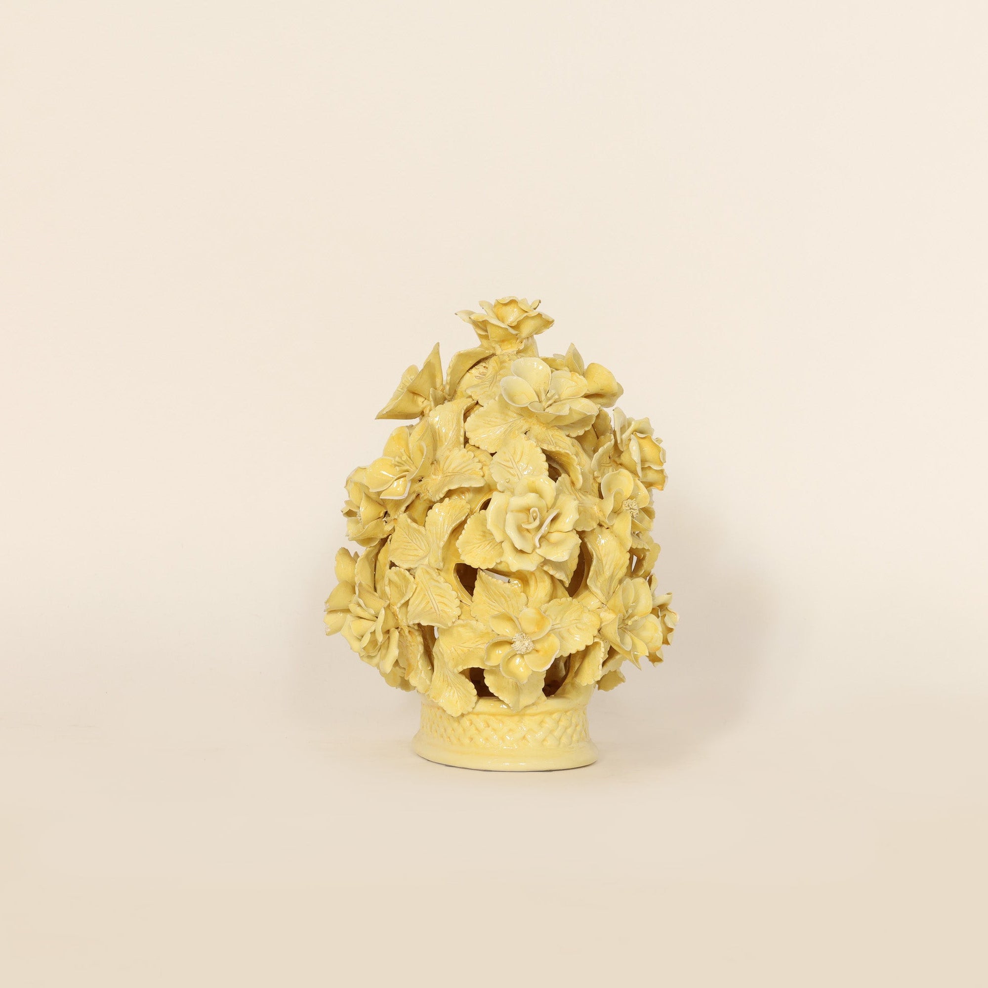Decorative yellow ceramic with floral design on a beige background