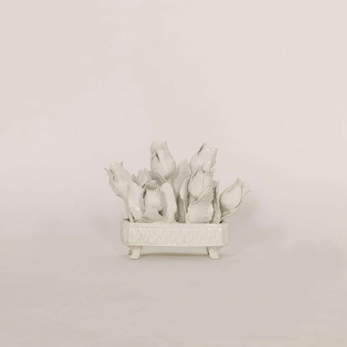 Decorative white ceramic plant on a beige background