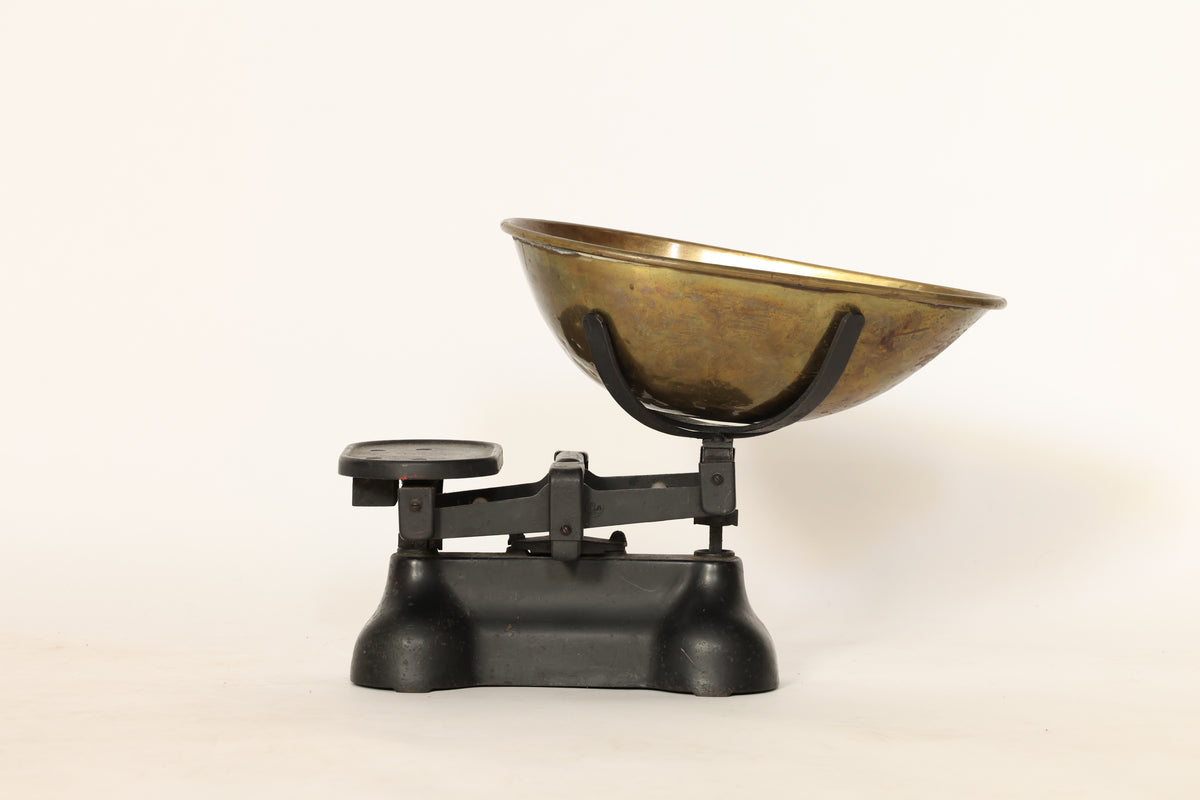 Vintage-style scale with a brass bowl on a white background