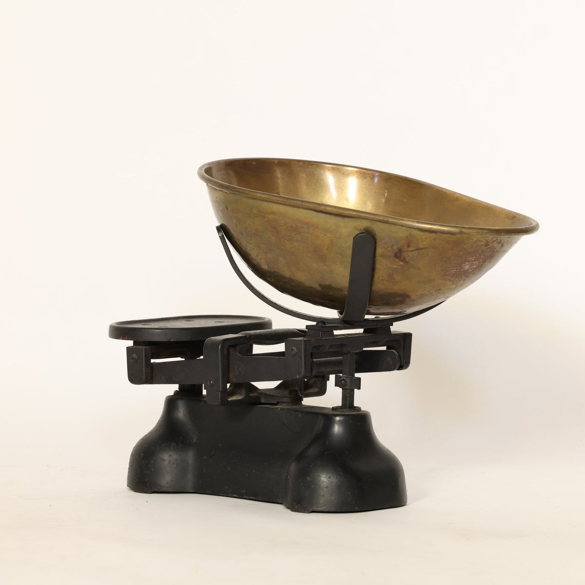 Vintage-style kitchen scale with a brass bowl on a white background