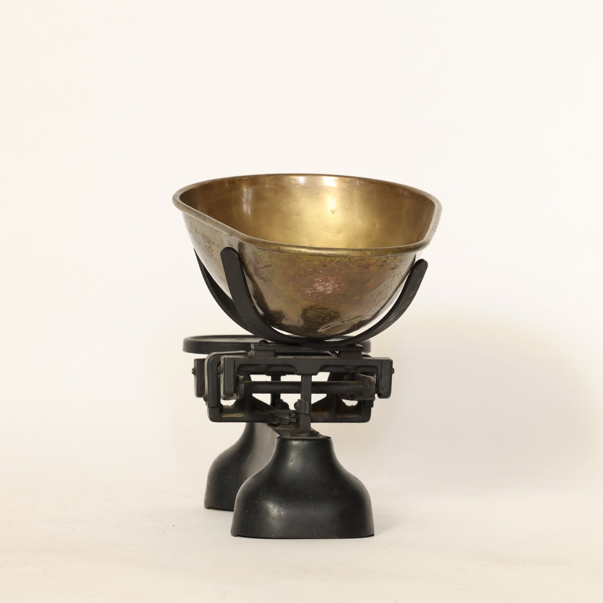 Bronze bowl on a black scale against a white background