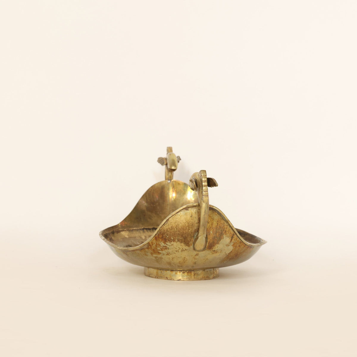 vintage brass centerpiece bowl on a beige background