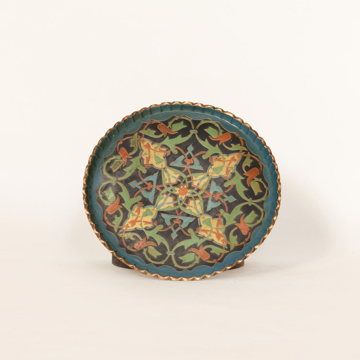 Decorative plate with intricate patterns on a white background