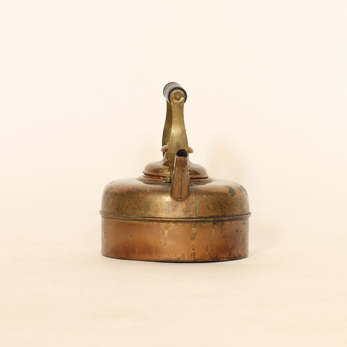 Vintage brass oil lamp on a beige background