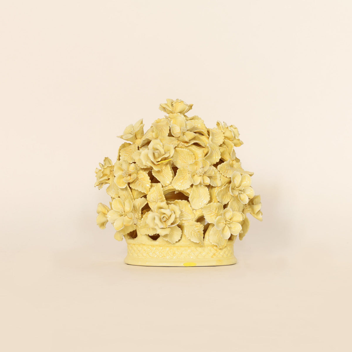 Decorative yellow floral sculpture on a beige background