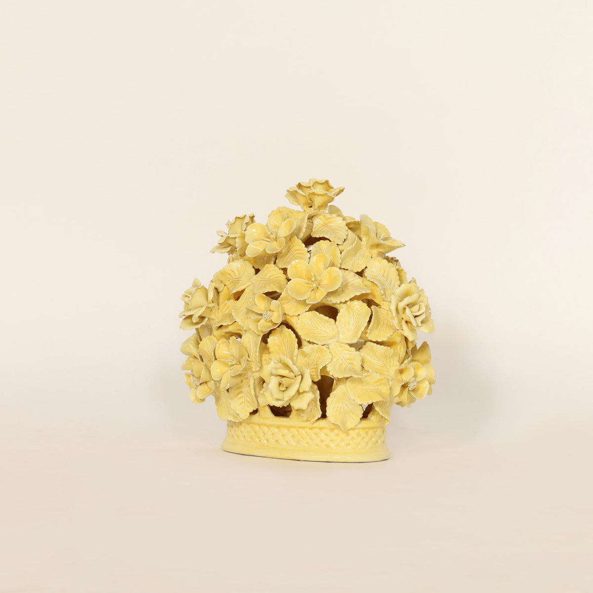 Decorative yellow ceramic with floral design on a beige background