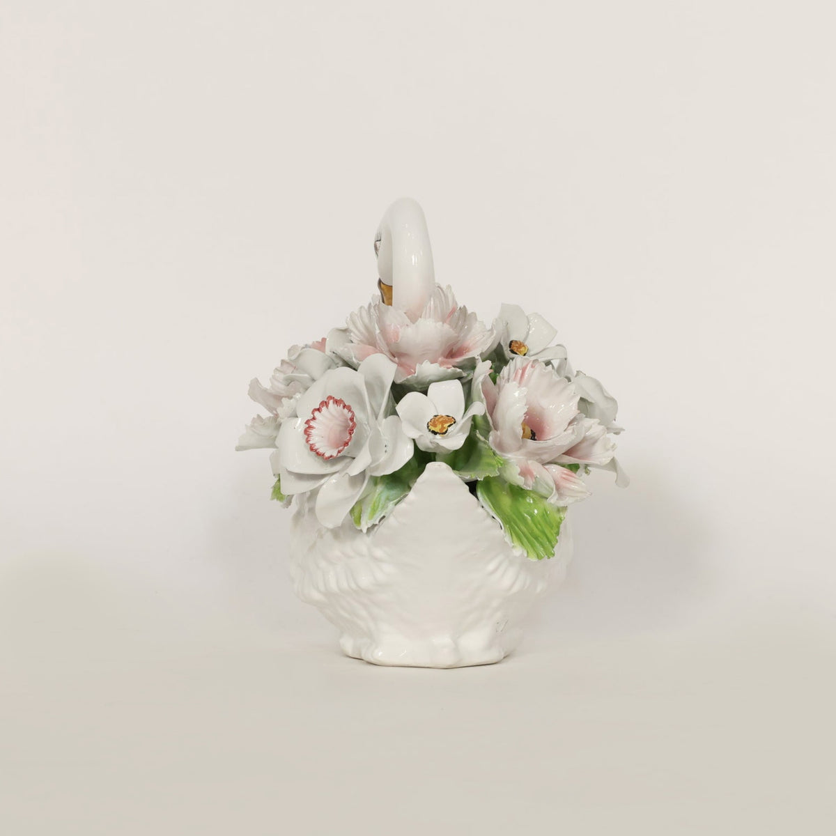 Decorative teapot with floral design on a light background