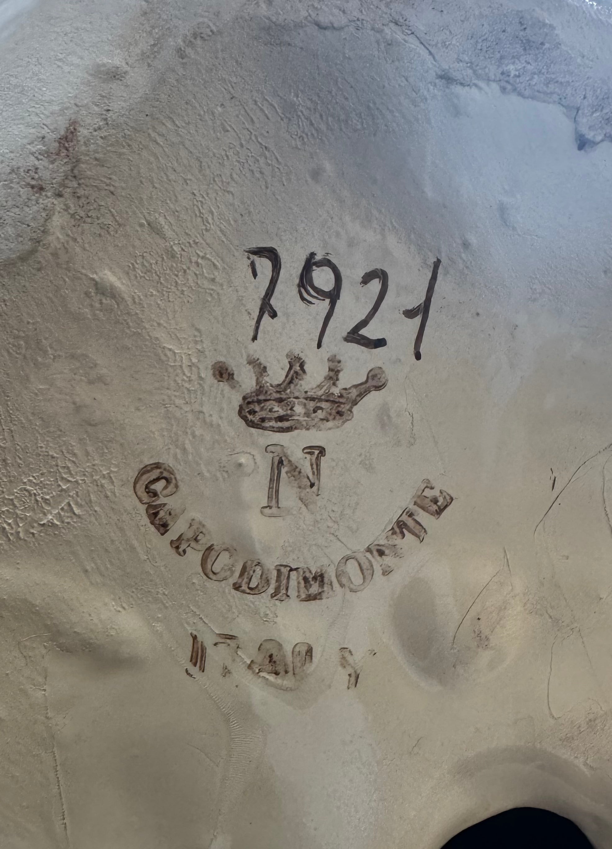 A close-up of the Vintage Floral Capodimonte Swan by Euro Trash Annie shows "7921" handwritten above a stamped crown, the letter N, and "Capodimonte" in raised letters on its textured ceramic floral surface.