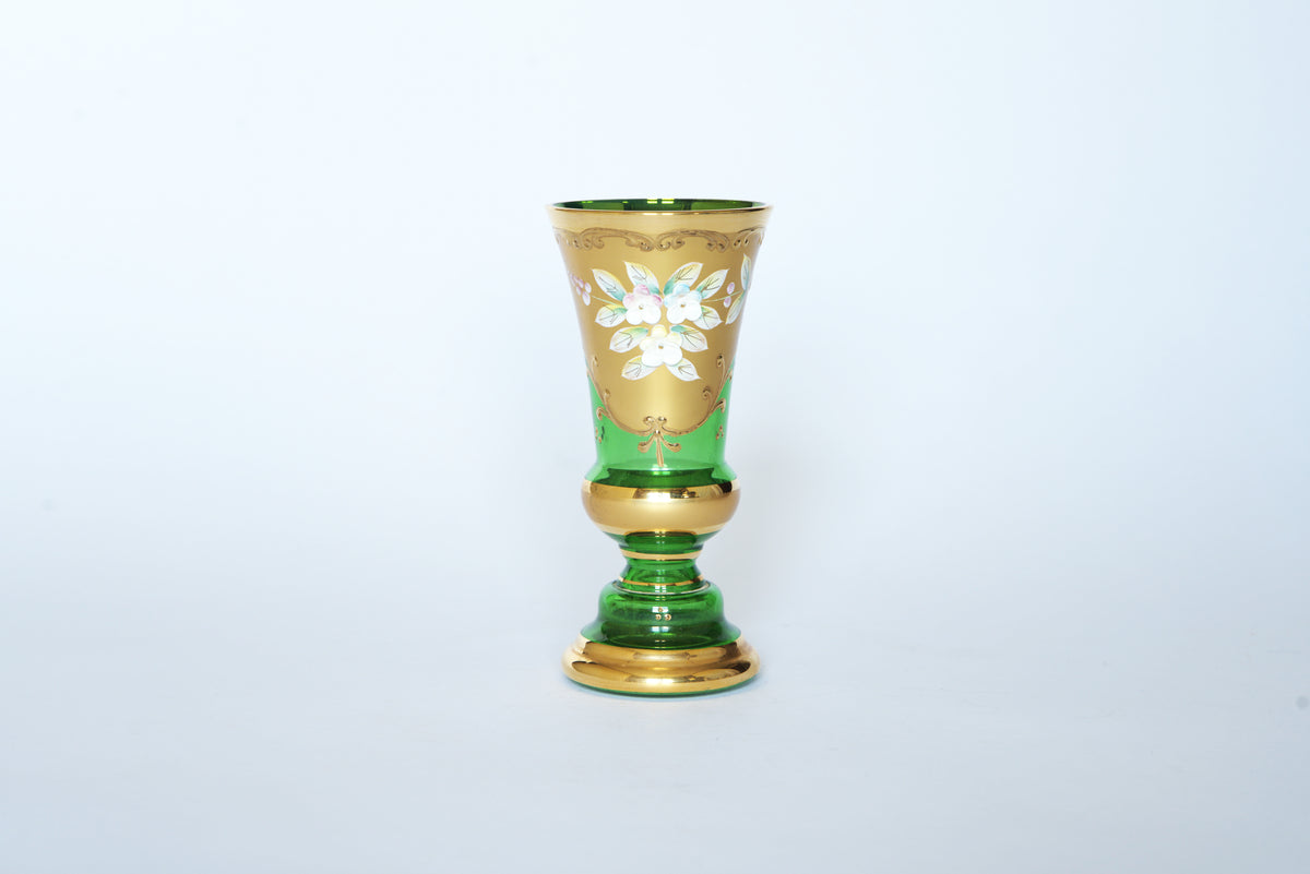 The Euro Trash Vintage Green & Gold Hand-Painted Floral Glass Vase features an emerald green base, gold accents, and a delicate white floral design, beautifully detailed on the upper portion and set against a plain white background.