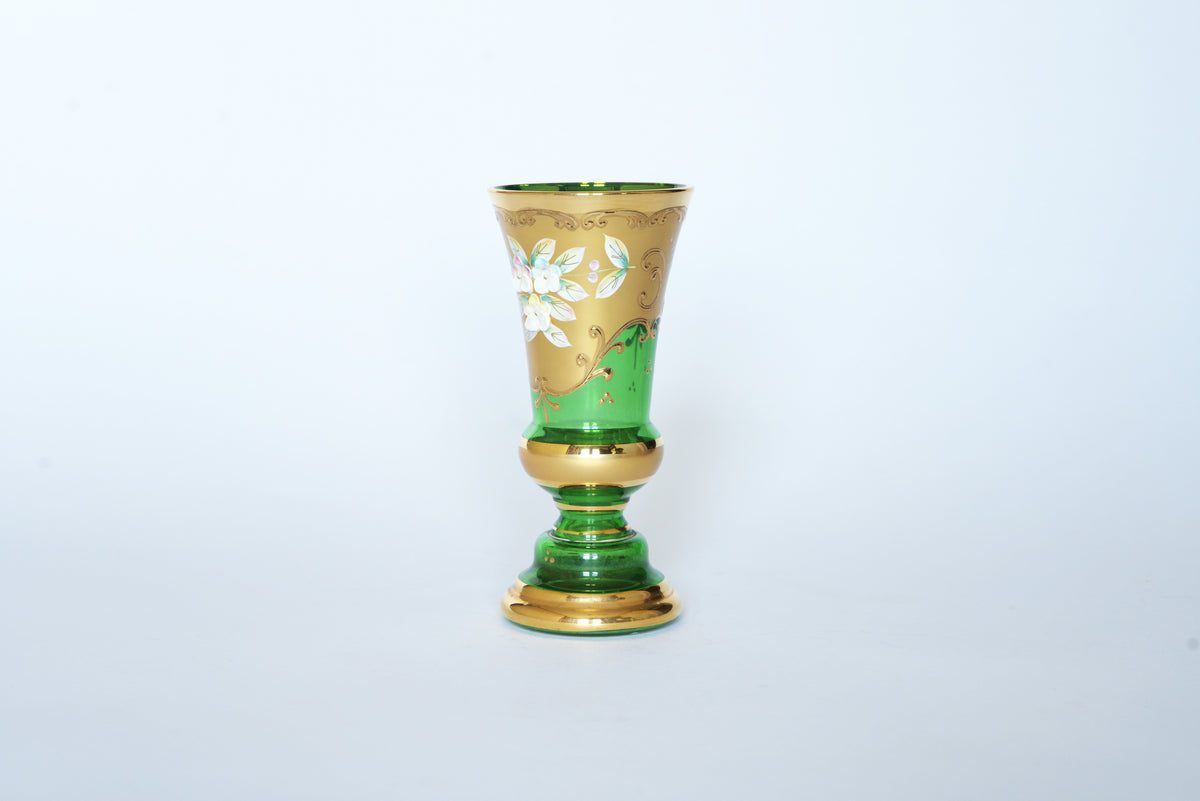 The Euro Trash Vintage Green & Gold Hand-Painted Floral Glass Vase features elegant emerald glass with white flowers and gold accents, capturing vintage charm against a plain white background.
