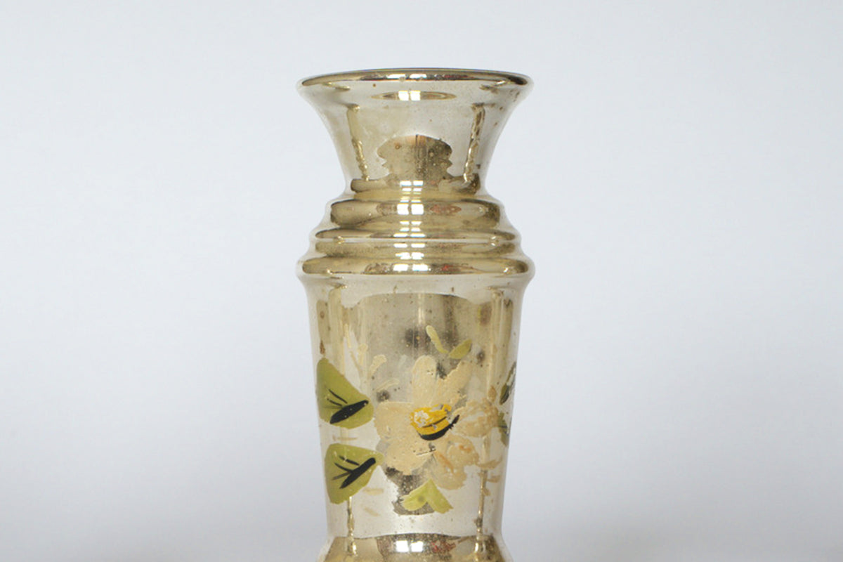 The Euro Trash Vintage Hand-Painted Mercury Glass Vase Set features gold-toned vases with narrow necks, flared rims, and floral designs of white and yellow flowers with green leaves, inspired by vintage mercury glass styles.