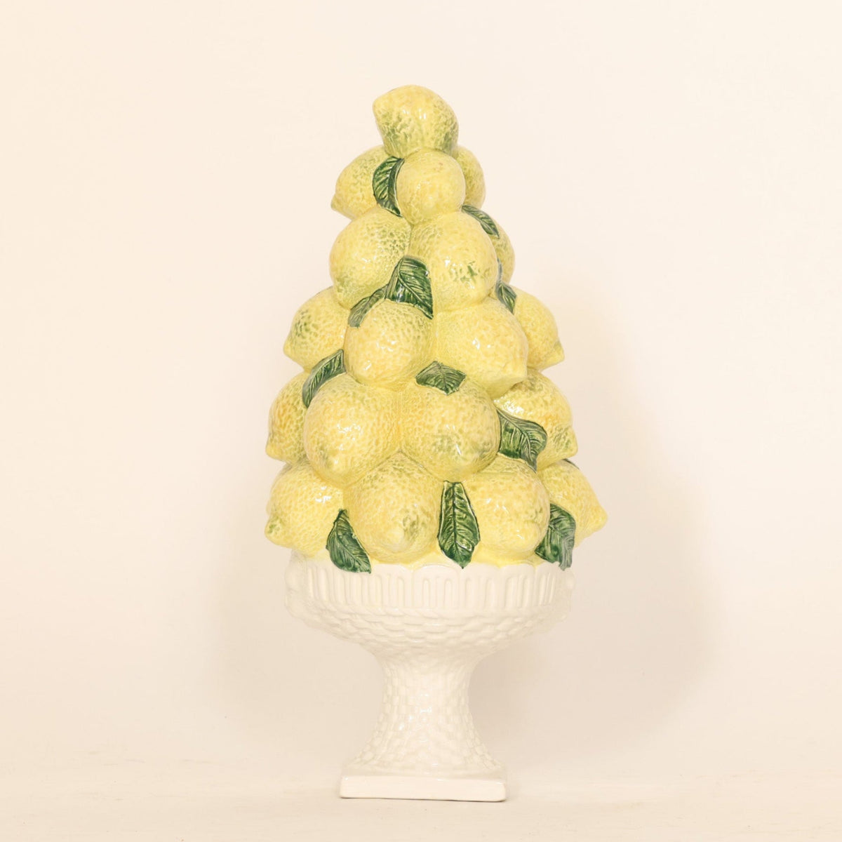 Decorative vintage lemon topiary centerpiece on beige background