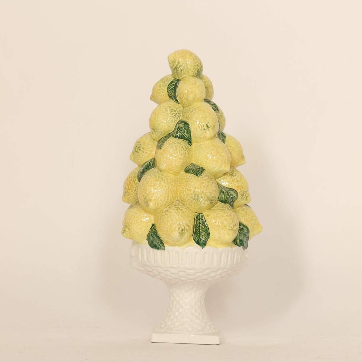 Decorative vintage lemon topiary centerpiece on beige background