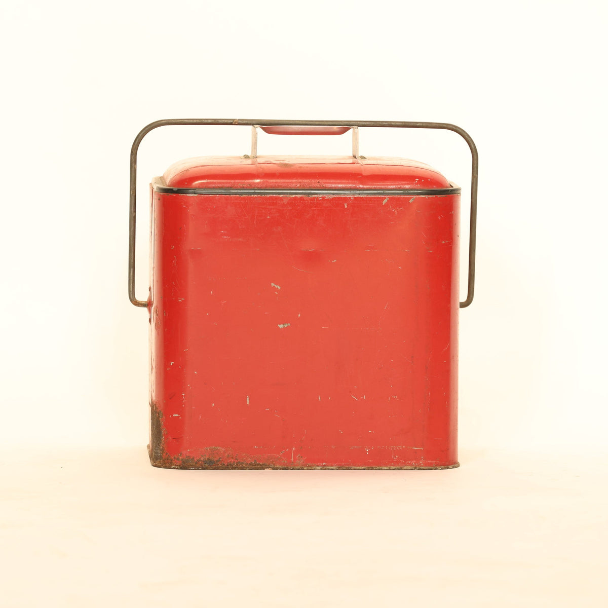 Vintage red metal box with a handle on a white background